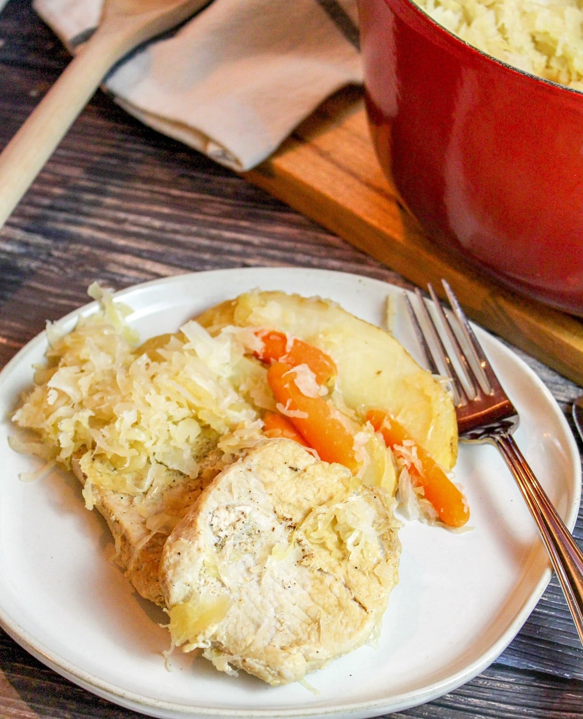 pork chops with sauerkraut on a plate with a fork