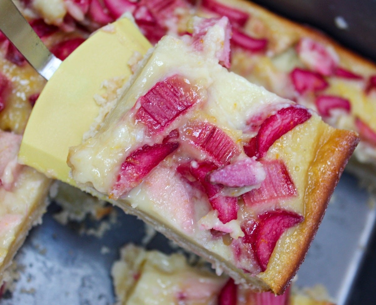 citrus rhubarb custard bars scooped from pan