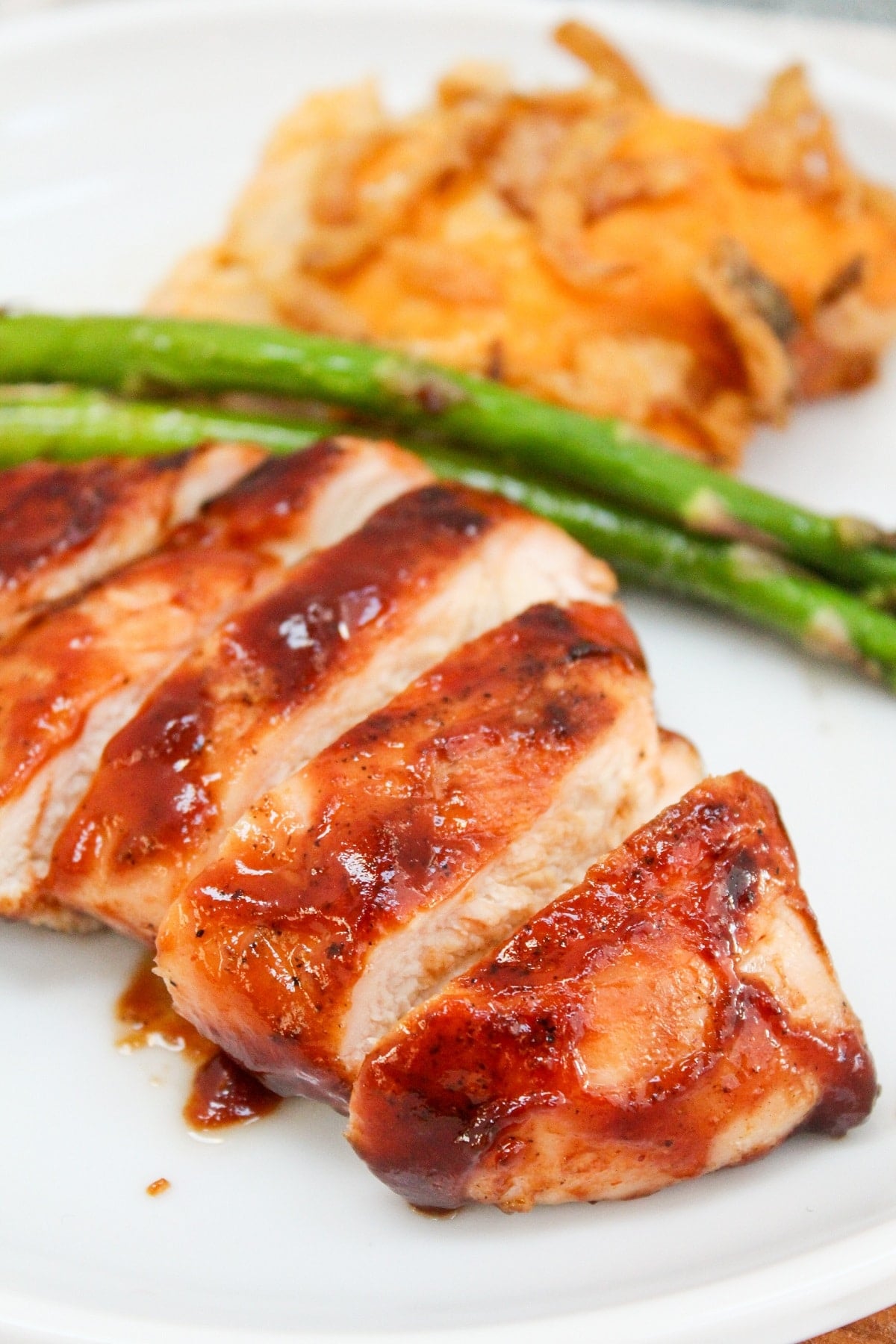 bbq chicken on a plate with asparagus