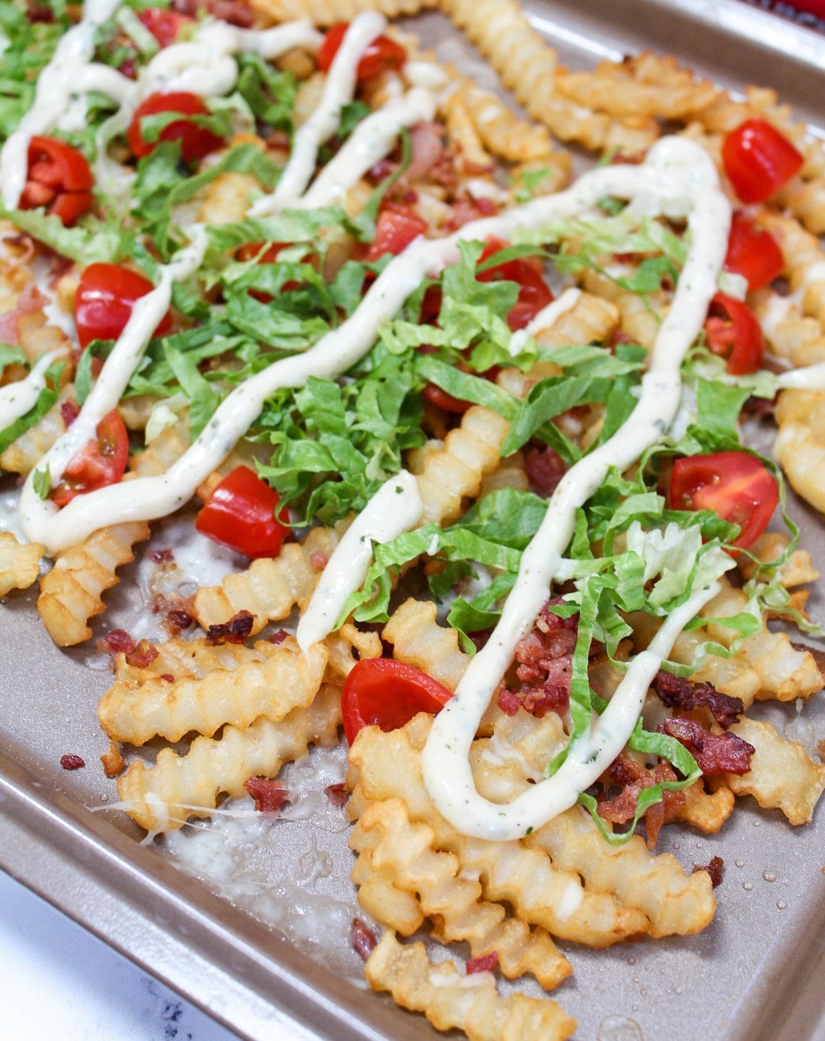 completed loaded blt fries on tray