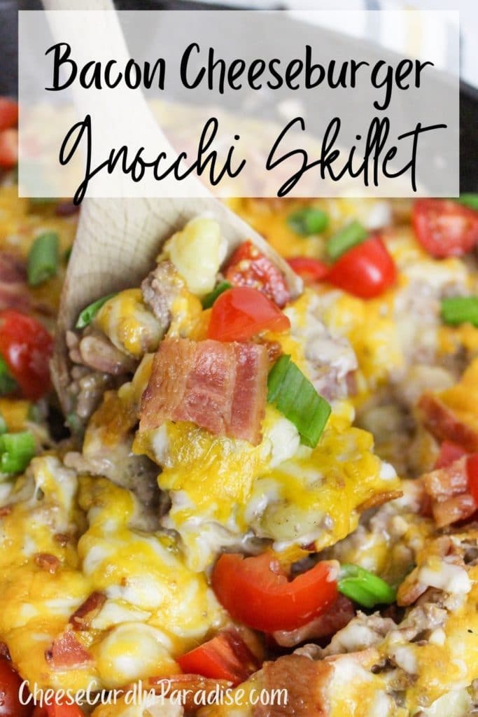 Bacon Cheeseburger Gnocchi Skillet in cast iron skillet scooped with a spoon