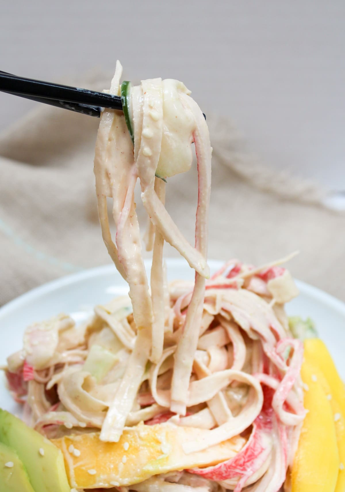 kani salad picked up with chopsticks