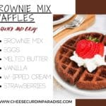 Brownie mix waffles with whipped cream and strawberries on top on a white plate