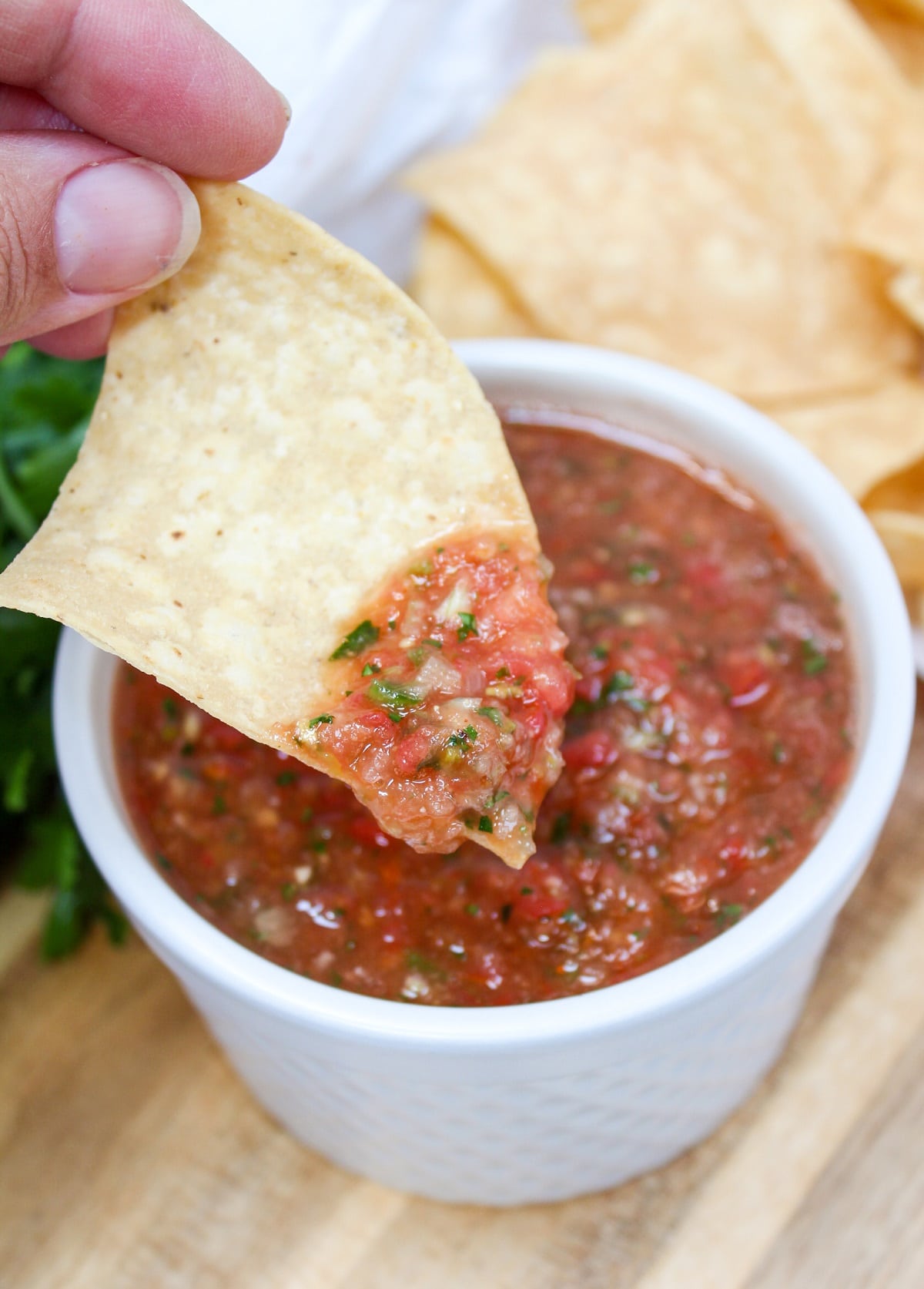 tortilla chip dipped in blender salsa
