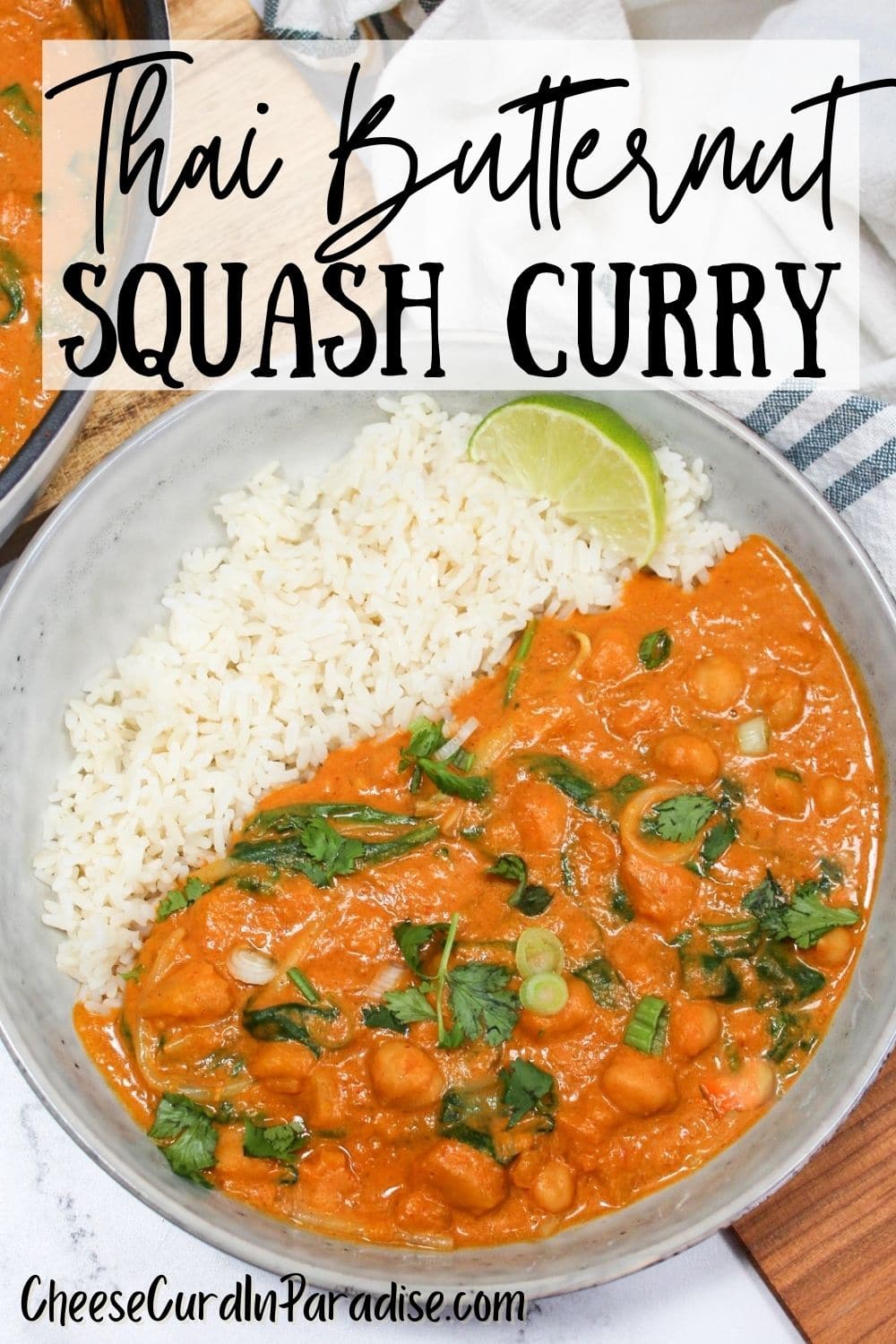thai butternut squash curry in a bowl with rice next to a skillet with more curry