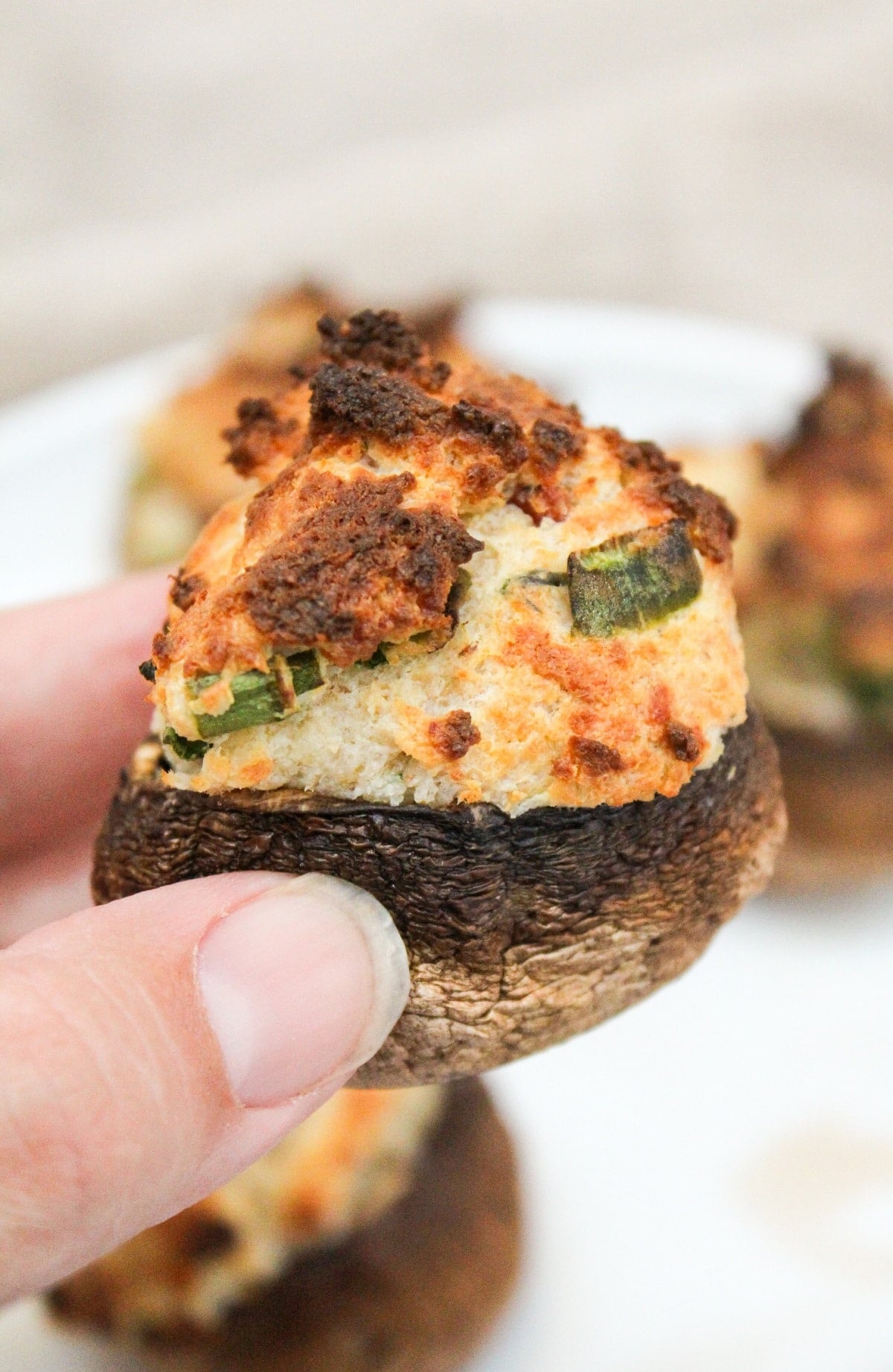 air fryer stuffed mushroom held in hand