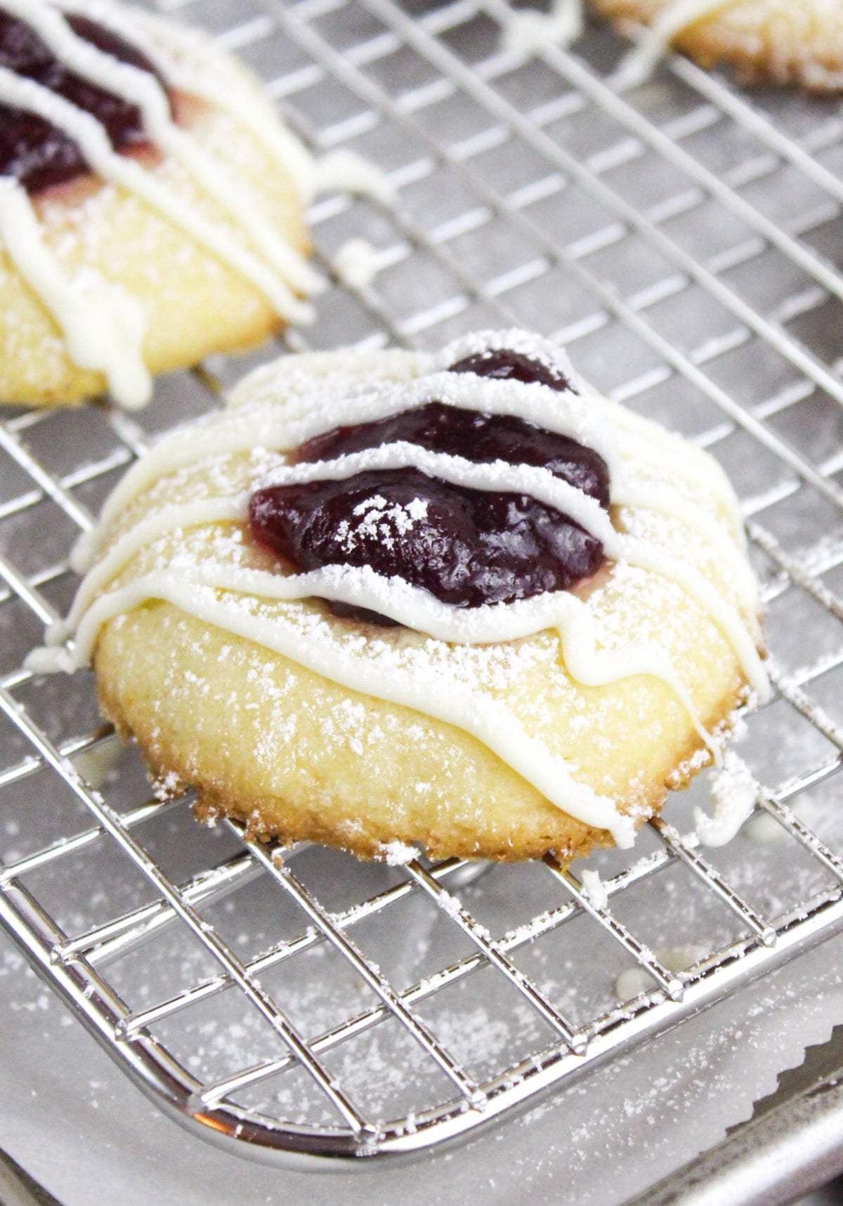 cranberry thumbprint cookies on a baking sheet