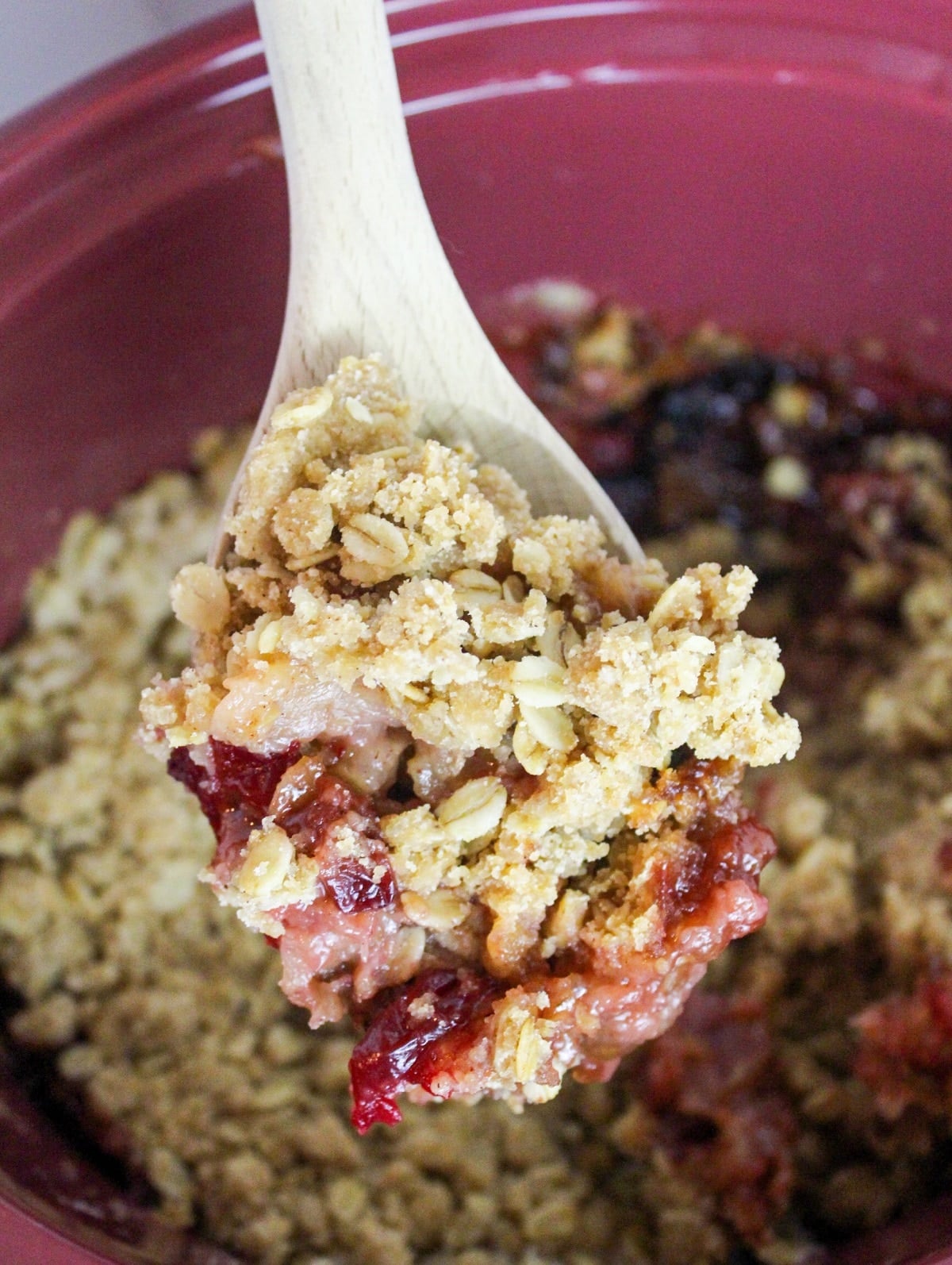slow cooker cranberry apple crisp on a spoon