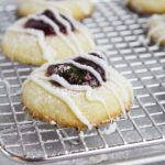 cranberry thumbprint cookies on a baking sheet