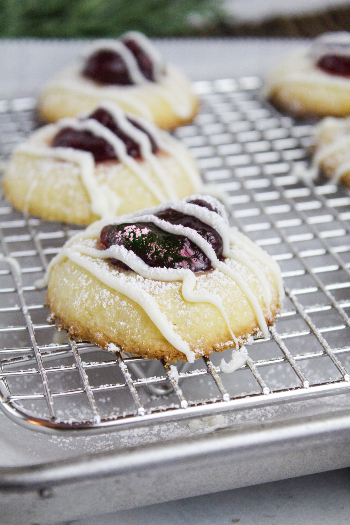 cranberry thumbprint cookies on a baking sheet