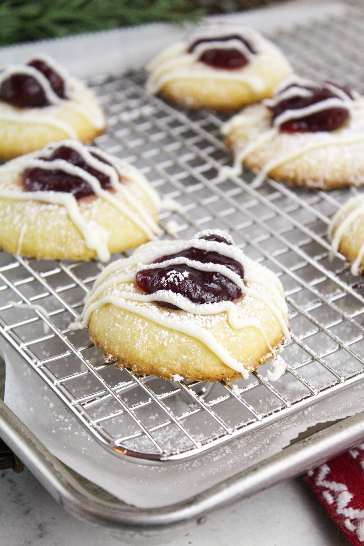 cranberry thumbprint cookies on a baking sheet