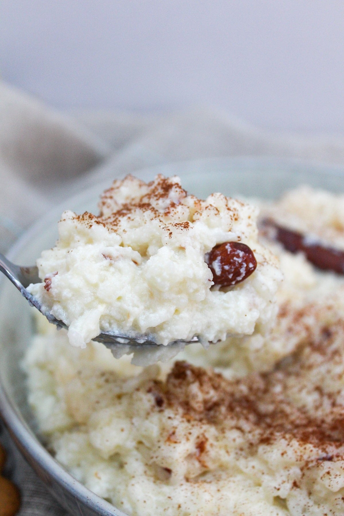 swedish rice pudding on a spoon with an almond