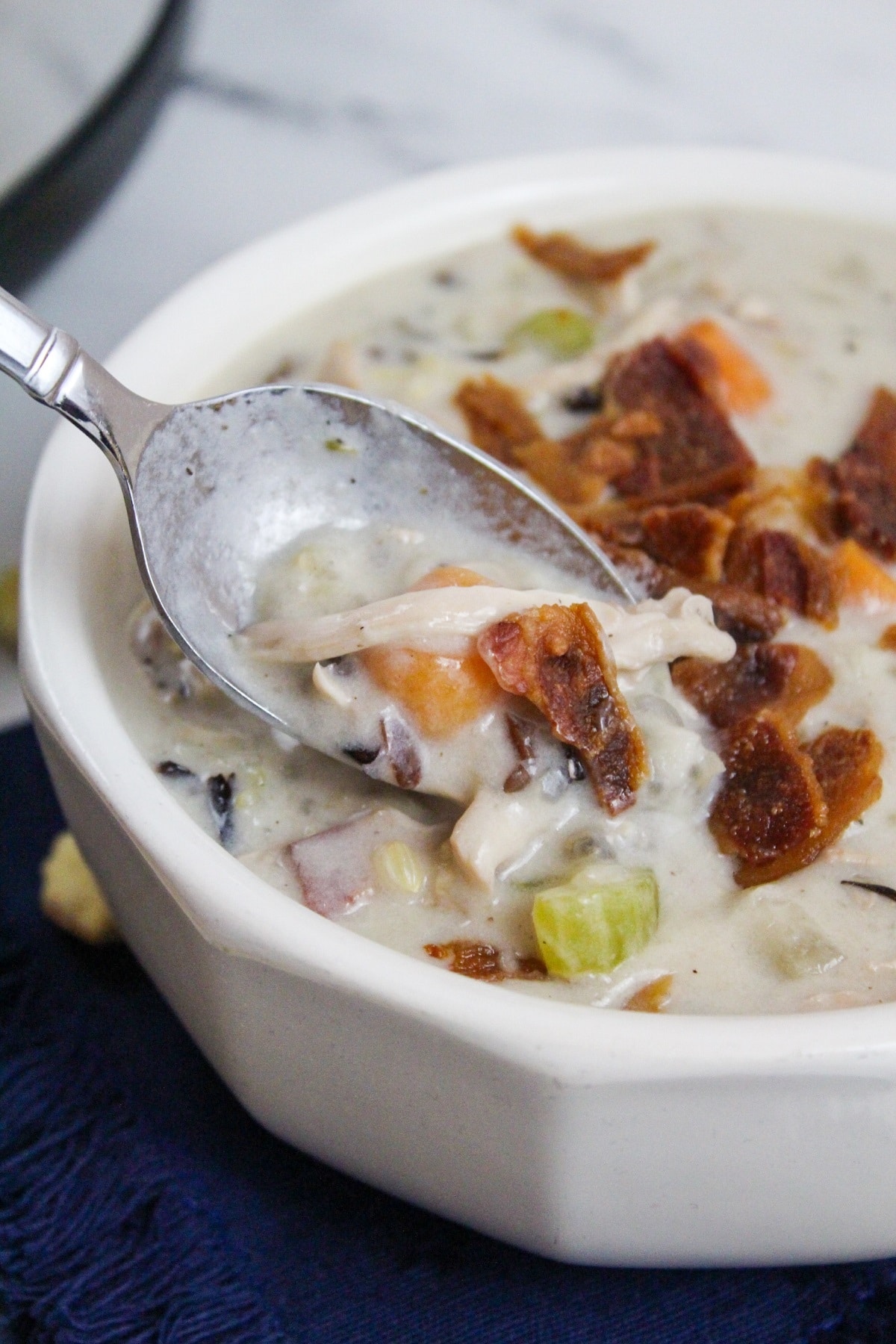 slow cooker creamy chicken and rice soup with spoon