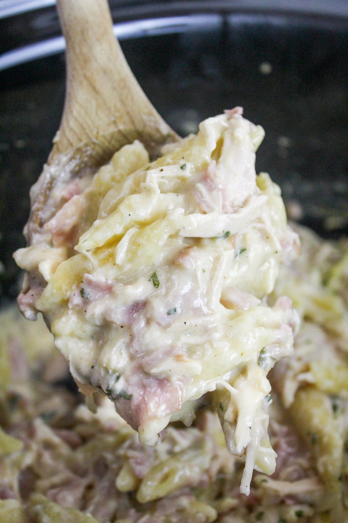 chicken cordon bleu pasta on a wooden spoon