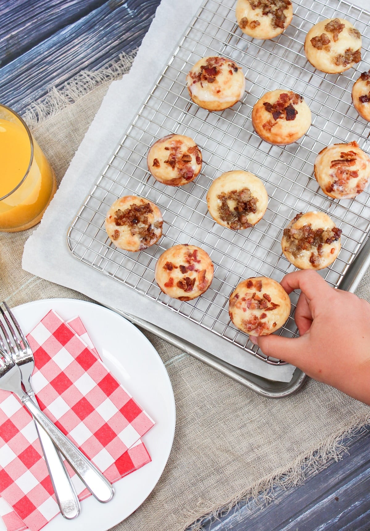 hand reaching for a pancake bite on a baking tray