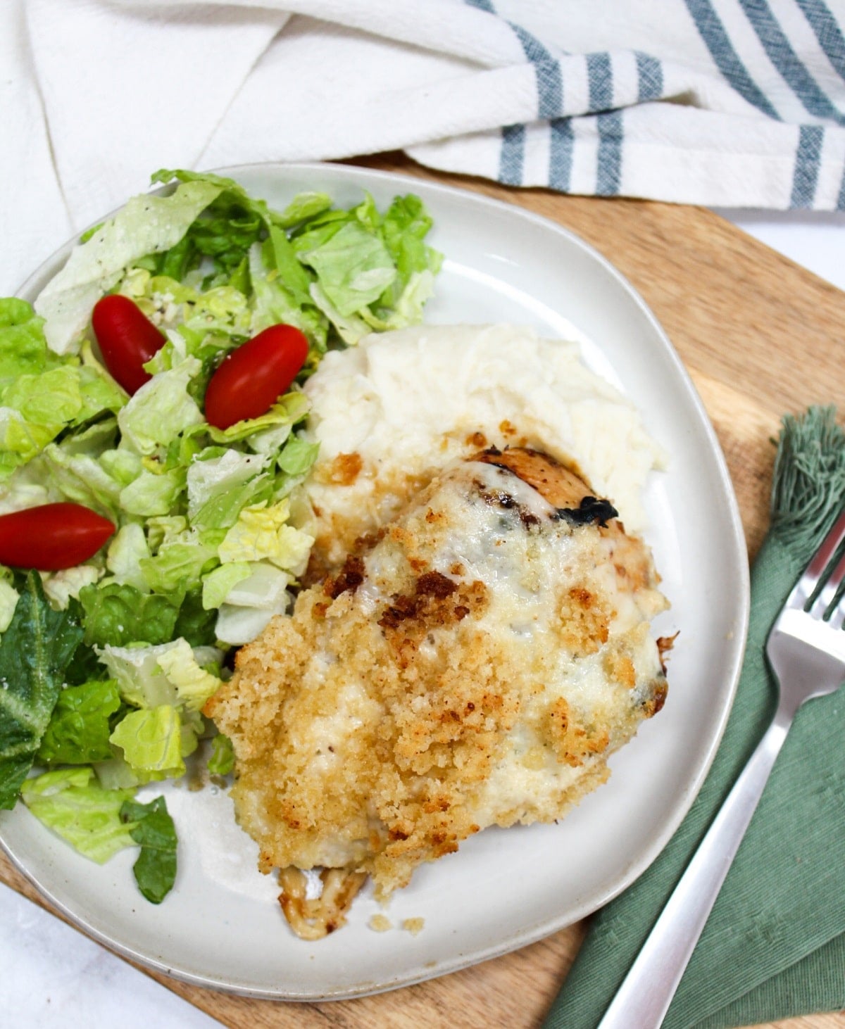 Longhorn Steakhouse Parmesan Chicken on a plate with salad