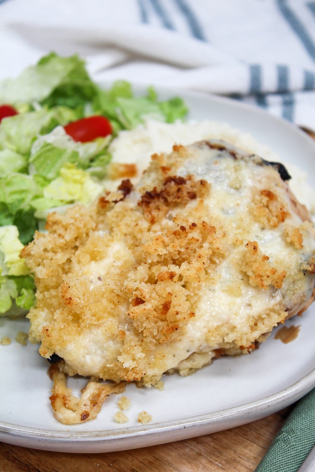 Longhorn Steakhouse Parmesan Chicken on a plate with salad