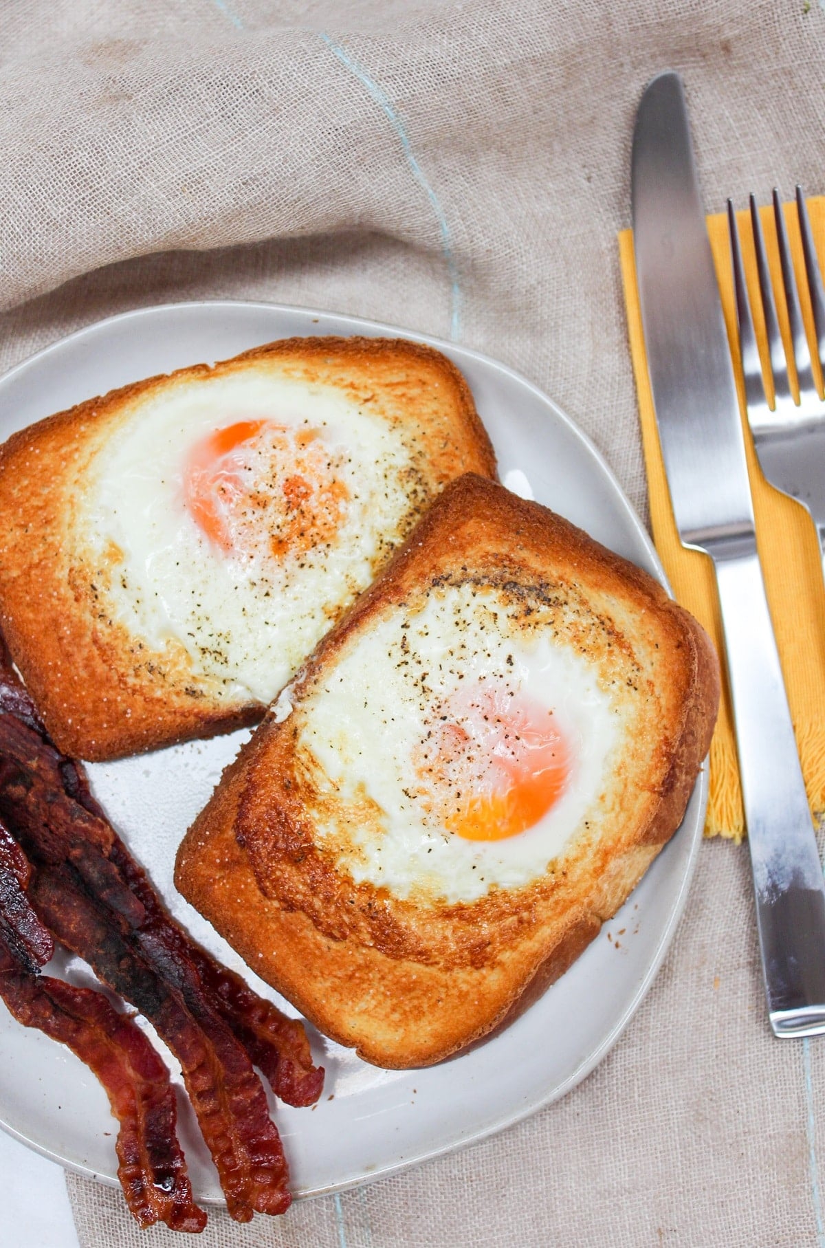 air fryer egg toast on a plate with bacon