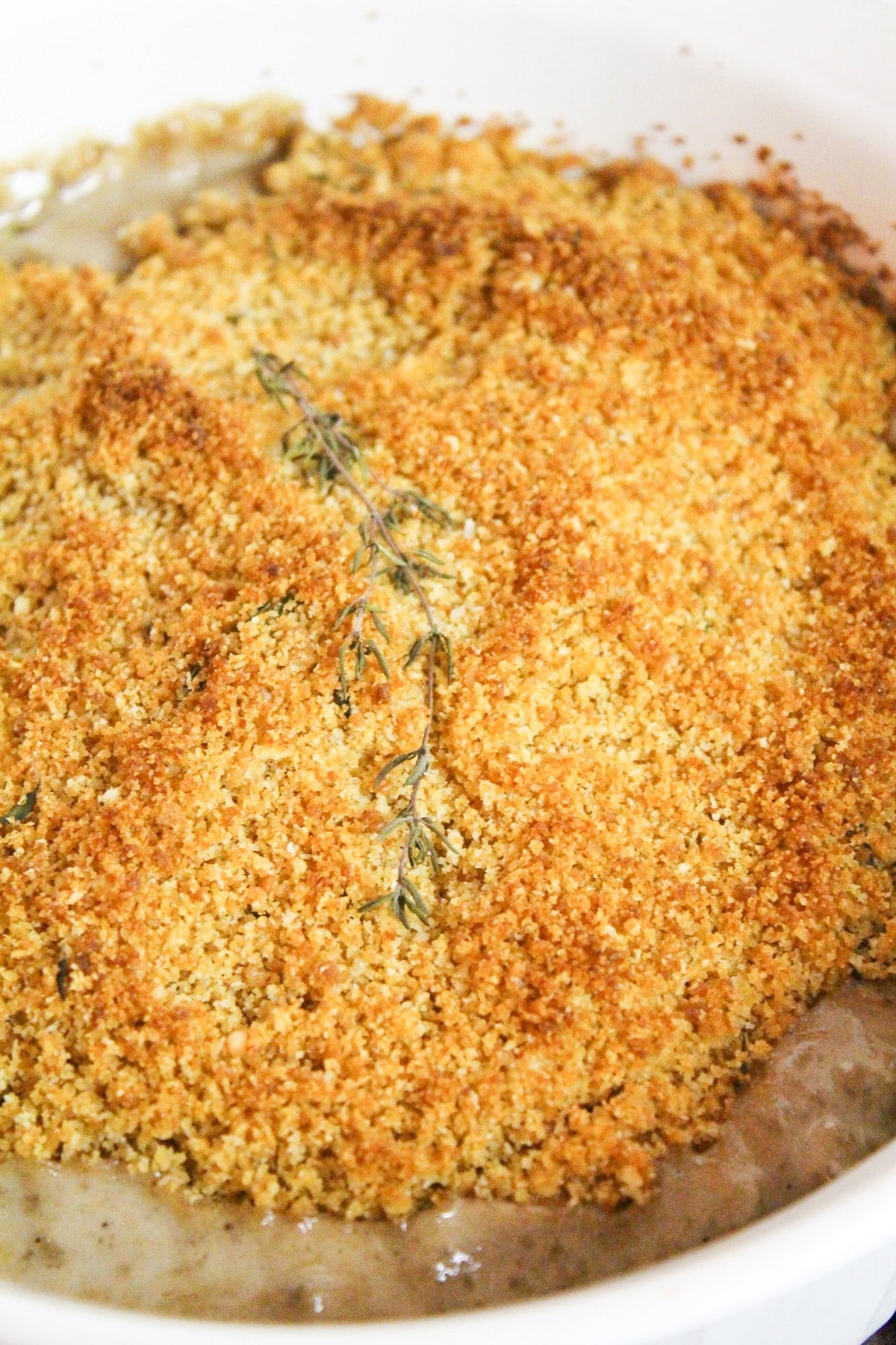 creamy mushrooms baked with a breadcrumb topping topped with fresh thyme.