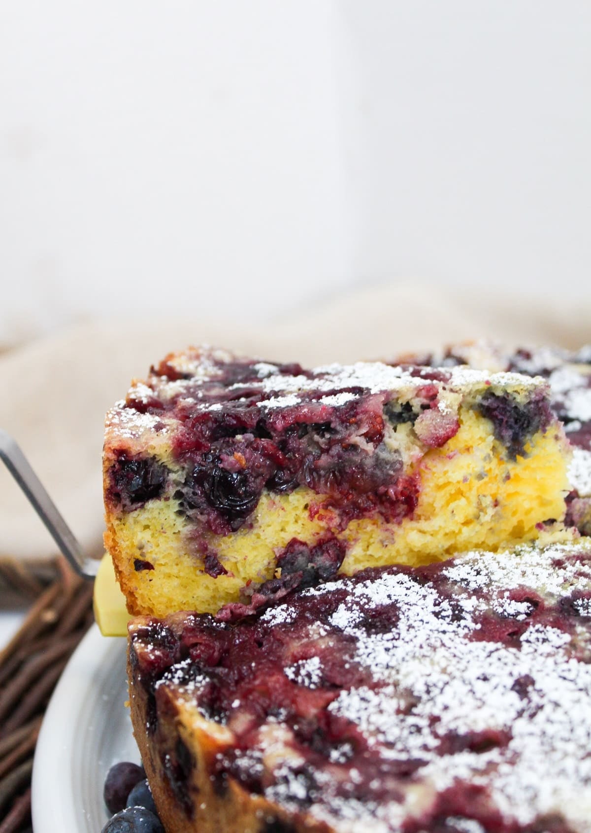 a slice of cake lifted from the round cake pan.
