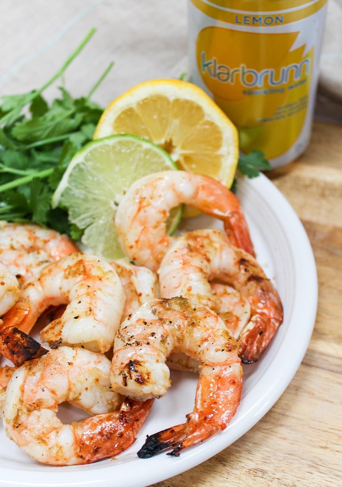 Grilled shrimp on a white plate.