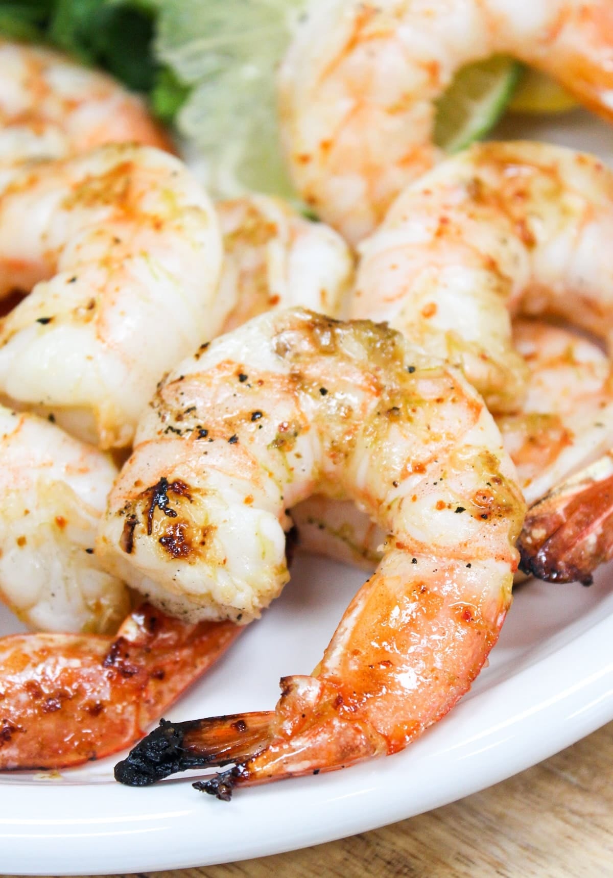 Grilled shrimp on a white plate.