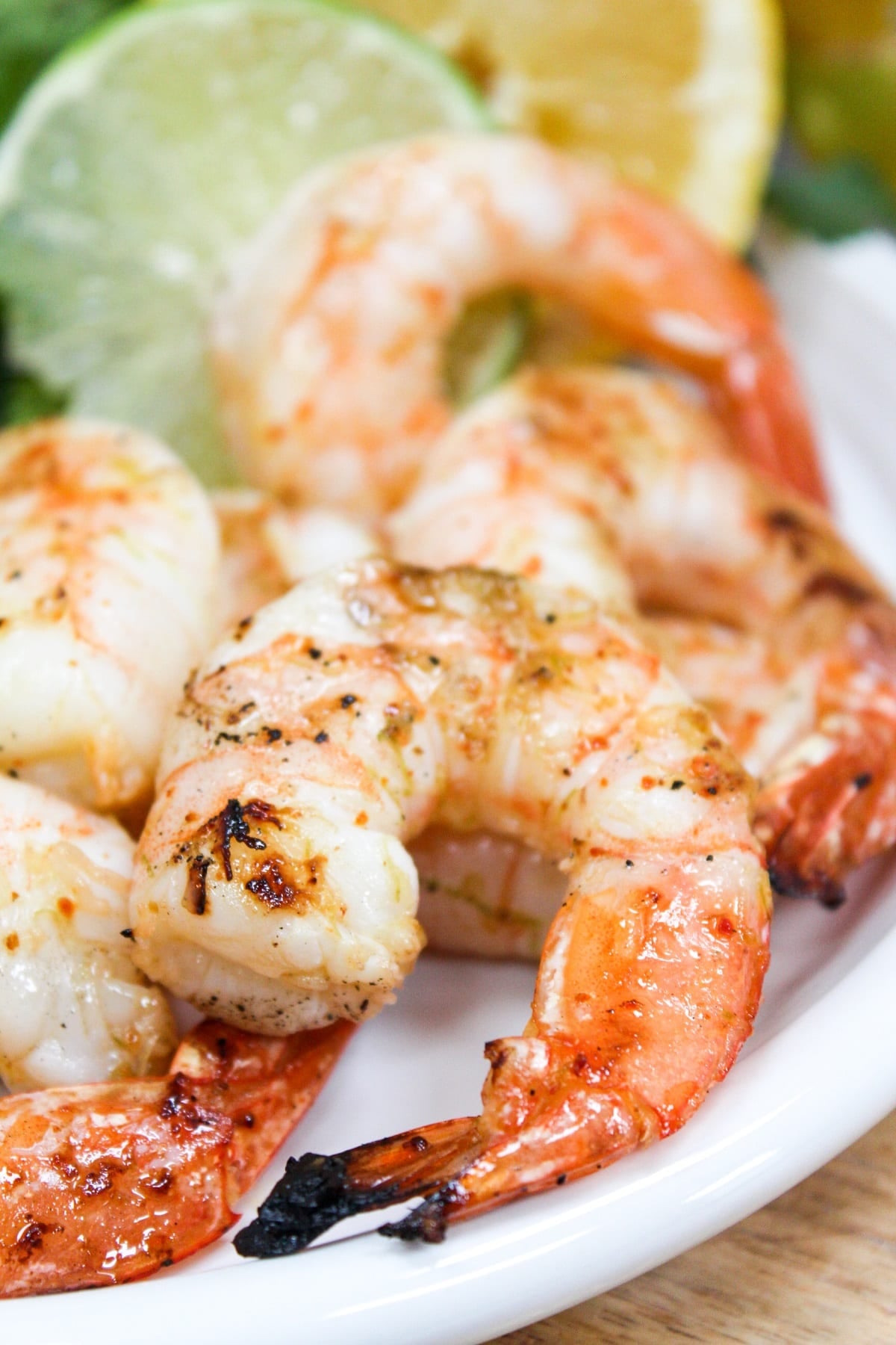 Grilled shrimp on a white plate.