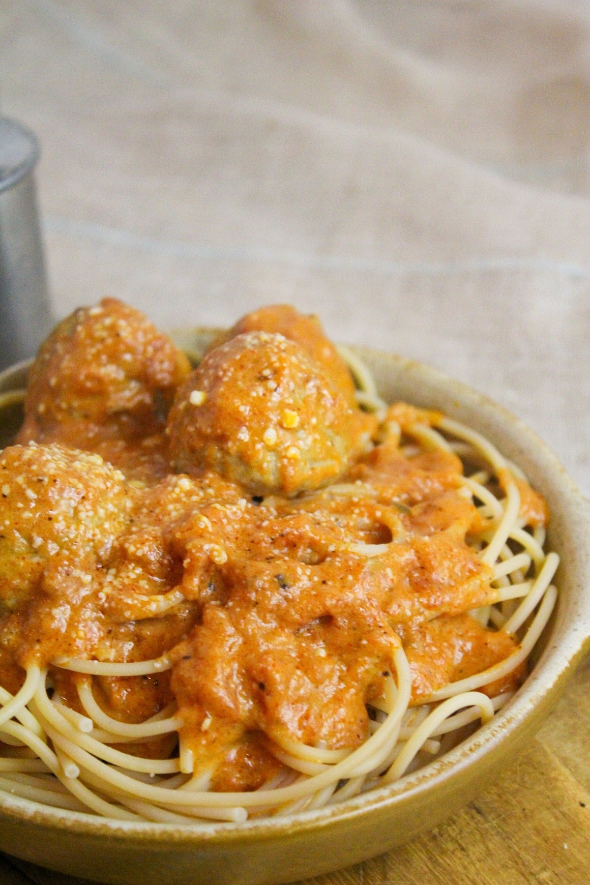 Meatballs cooked in a creamy tomato sauce over spaghetti.