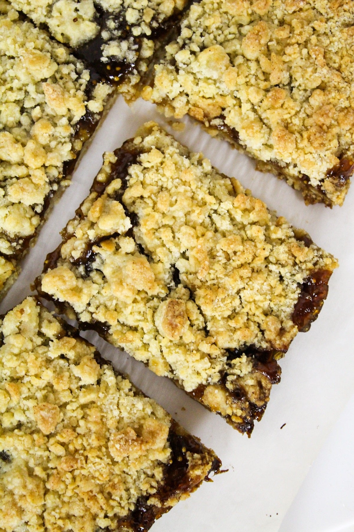 Overhead photo of a cut fig dessert bar with a crumb topping.