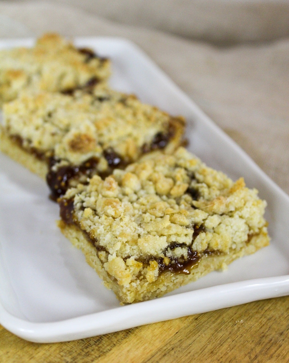 Fig dessert bars cut and on a white plate.
