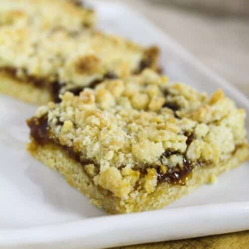 Fig dessert bars cut and on a white plate.