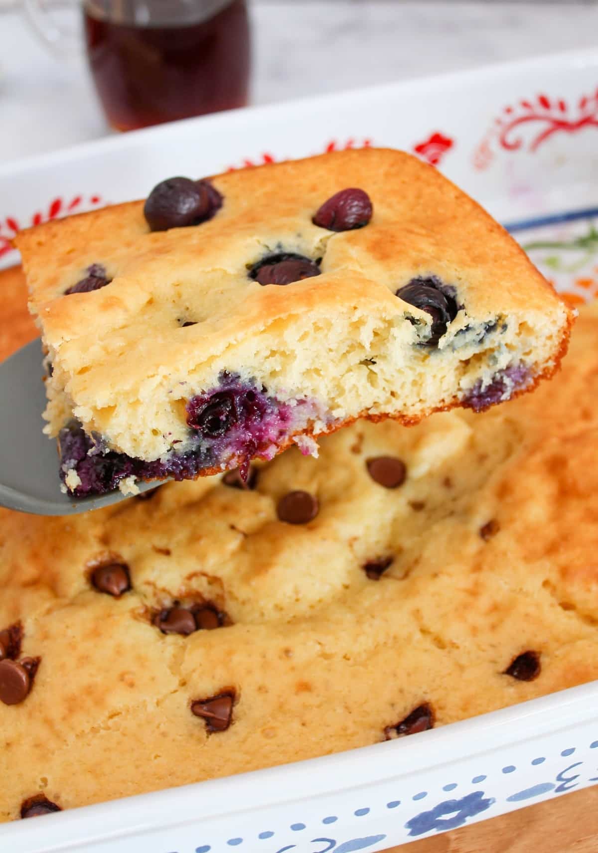 Slice of a blueberry pancake lifted from the sheet pan dish.