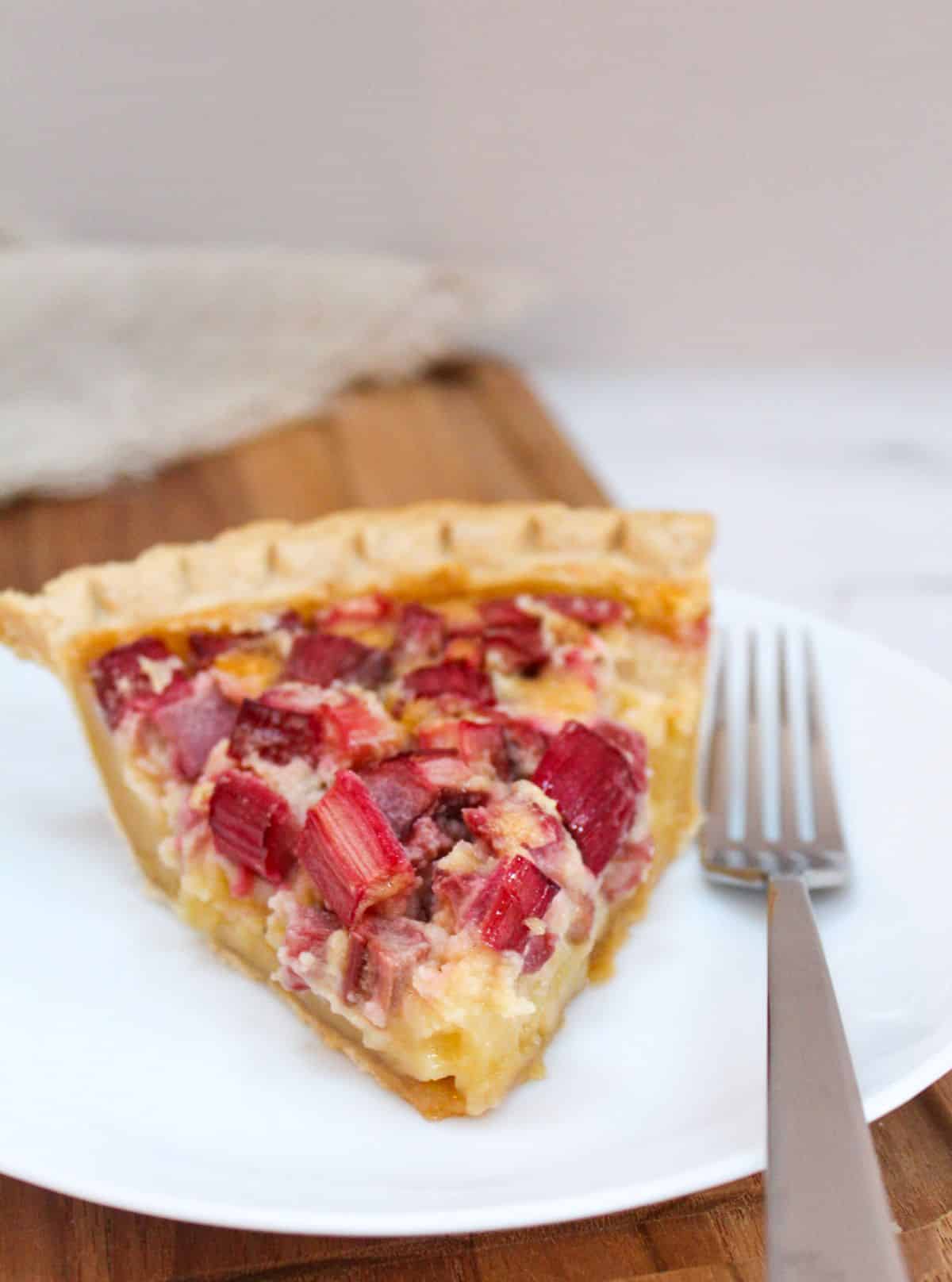 Rhubarb Custard Pie on a plate with a fork.